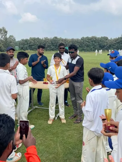 An award ceremony for our U12 champions at the Cricket Beyond Technique tournament. Here, a player receives his medal for his contribution to the team's success.