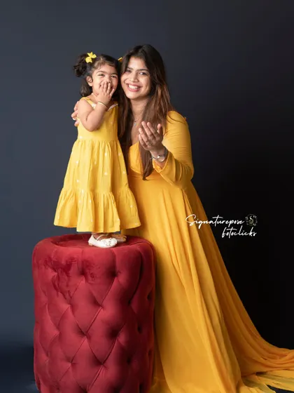 A fun and playful pose during a mother-daughter photoshoot. These candid moments of laughter and interaction create the most authentic and cherished memories.
