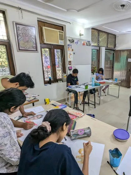 Another busy day in the studio. You can see students working on various projects, from portraits to still life, with instructors available to guide them.