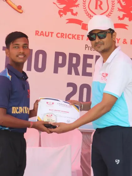 A young player from the RCA Titans is awarded his certificate for participation.