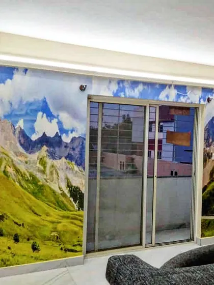 Bring the mountains home with a custom landscape mural. This installation covers the entire wall, creating an immersive view that makes the room feel vast and open.