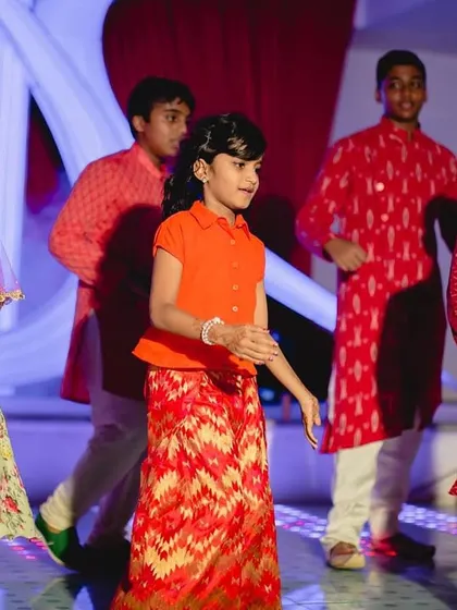 A candid moment from a kids' group dance. We teach them simple, coordinated moves that are easy to remember, so they can perform with confidence and have a great time.