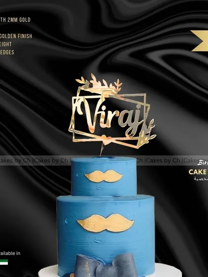 This "Viraj" name topper is shown on a two-tiered "little man" themed cake with golden mustaches. It's a great example of how a topper can tie a whole theme together.