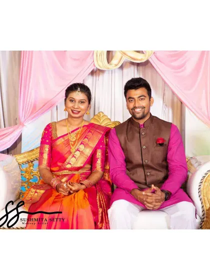 An adorable couple portrait from their engagement day. The bride's makeup is bright and fresh, with a beautiful pink and orange saree that makes her glow.