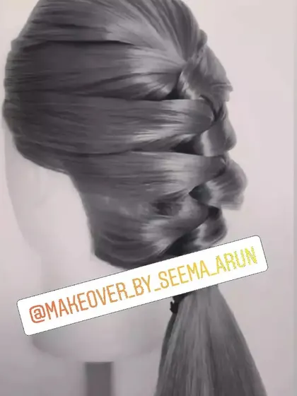 A sleek and modern twisted ponytail. This polished hairstyle is perfect for a professional portfolio shoot or a chic party look, offering a sophisticated alternative to a simple ponytail.