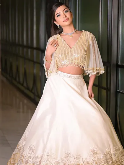 Dancing into the night with this elegant cocktail look. The combination of a shimmering gold and ivory outfit with soft, glamorous makeup is perfect for any celebration.
