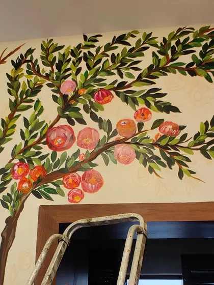 A work-in-progress shot of the boutique mural. You can see how the tree branches extend across the wall and around the doorway.