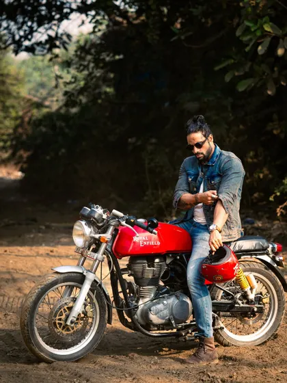 A relaxed pose with the motorcycle, capturing the cool, easy-going vibe of a rider.