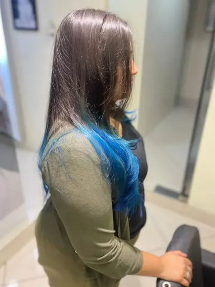 This client opted for a pop of color with these beautiful blue ends. This dip-dye technique is perfect for adding a playful and edgy touch to long hair.