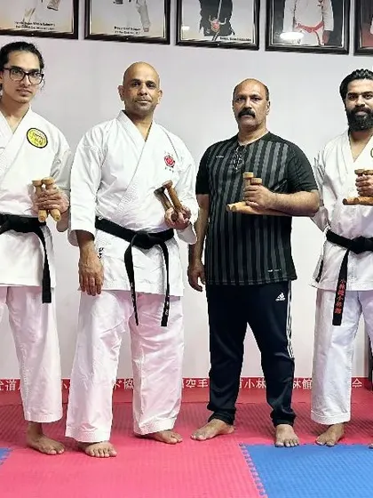 Another group photo with my instructors, holding the Tekko, another traditional Okinawan weapon.