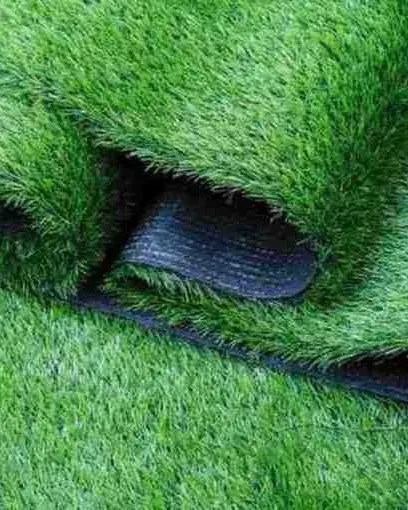 The quality of our turf is visible in its construction. This close-up reveals the dense fibers and robust, multi-layer backing that give our artificial grass its exceptional durability and long-lasting performance.