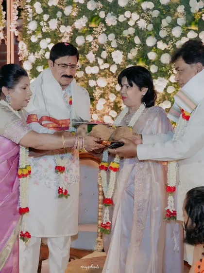 A moment of tradition during an engagement ceremony, where family members exchange blessings and gifts. Even amidst the celebration, I focus on these culturally significant details.