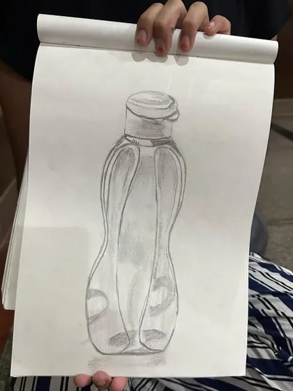 A student's sketch of a water bottle, a great exercise in drawing transparent and curved surfaces.