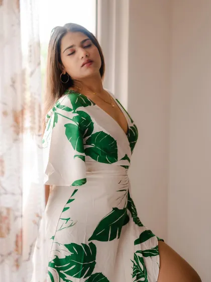 A serene portrait of a model by a window. The soft natural light and her peaceful expression create a beautiful and gentle indoor shot.