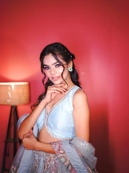 A close-up of the floral lehenga's blouse and the elegant hairstyle.
