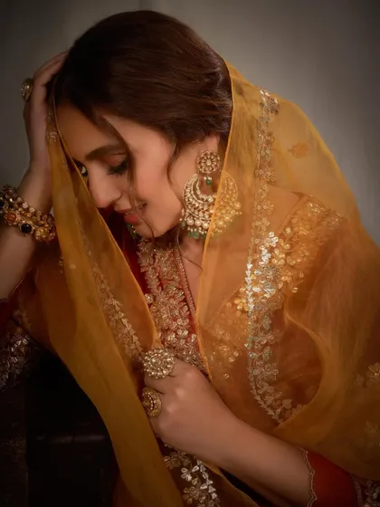 This intimate portrait captures the rich textures of the velvet and the sparkle of the jewelry. The warm tones and soft expression make this a truly beautiful festive shot.