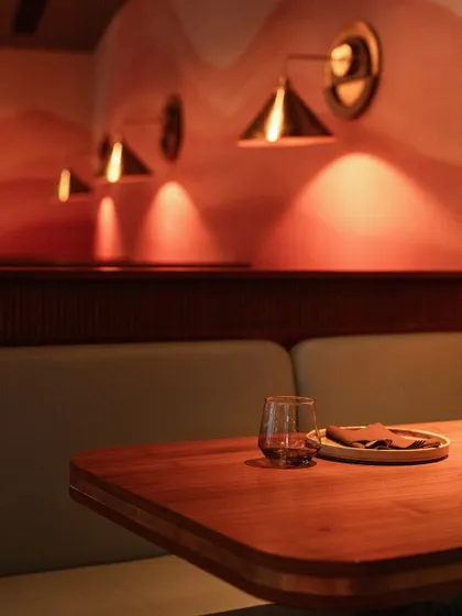 Even the simplest corner is designed with care. This cozy booth with its warm, focused lighting is a perfect example of our sophisticatedly casual style.