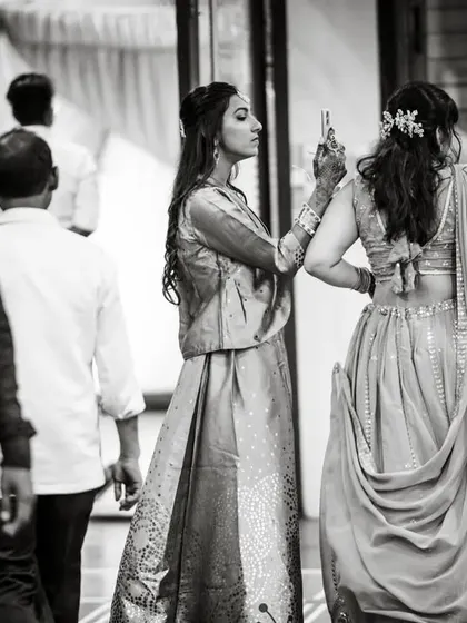 A candid moment from a Gujarati wedding, capturing guests in between events.