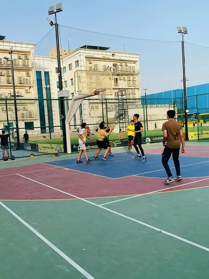 A player jumps for a shot in the key, surrounded by defenders.