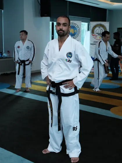 A moment of focus during a training seminar. I am surrounded by other dedicated black belts, all committed to deepening our knowledge of Taekwon-Do.