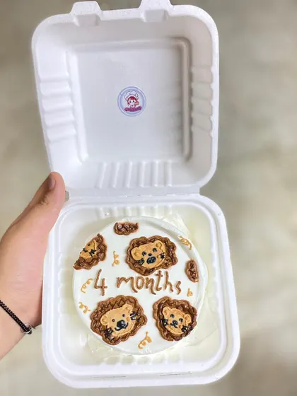 Celebrating the little milestones is so important. This chocolate caramel bento cake with cute lion faces was made to celebrate a baby's fourth month.