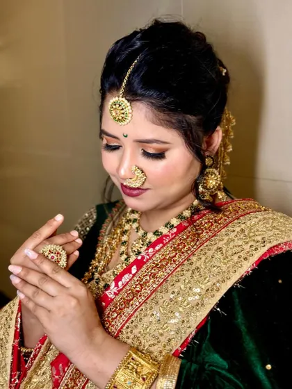 A close-up showing the intricate details of the bridal makeup and jewelry. The soft-focus eye makeup and perfectly placed bindi complete this Sundar Navri look.