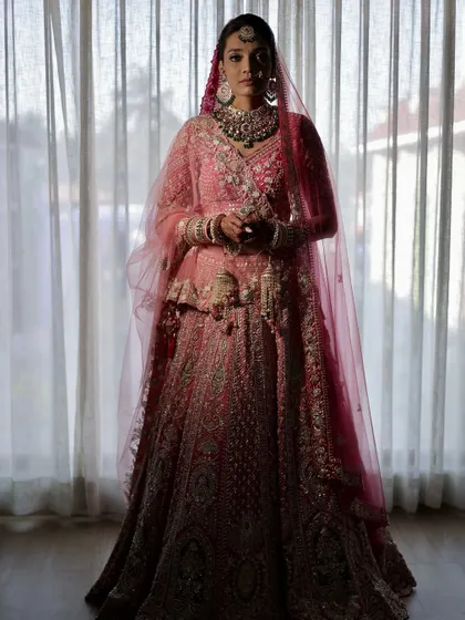 A silhouette shot that captures the grandeur of the bridal outfit. The makeup is designed to stand out even from a distance, with a defined profile and radiant finish.