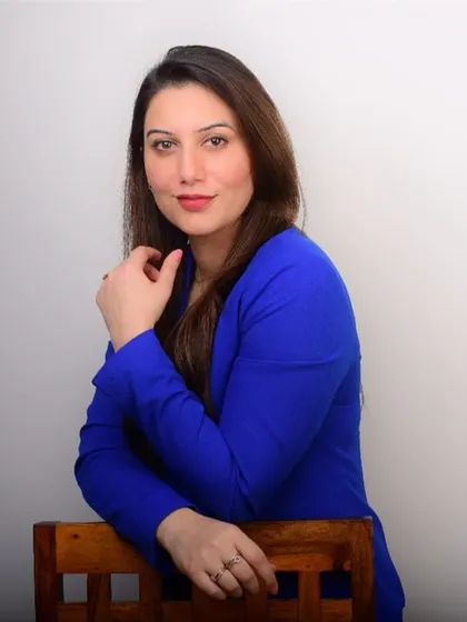 A relaxed and thoughtful pose for a doctor's profile. This shows a different side from the formal headshot, adding warmth and approachability.