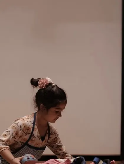 A young performer from 'The Elves and the Shoemaker' fully absorbed in her role. This level of focus is a key skill we cultivate in our classes.