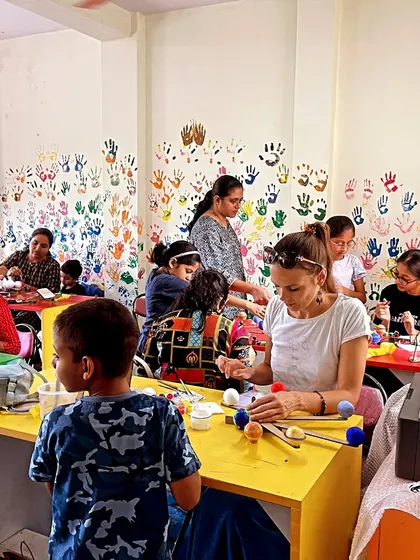 A full classroom of parents and children working side-by-side on their projects. These sessions are a great way to bond and create shared memories.