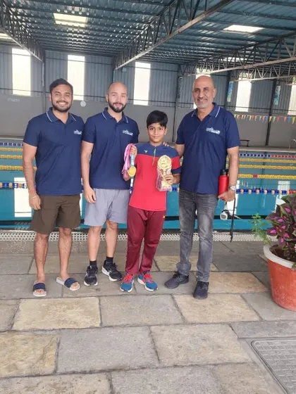 Bikka Thribhuvan Reddy, crowned Individual Champion at the Andhra Pradesh Short Course Meet, stands with his coaches after winning four golds and one silver.