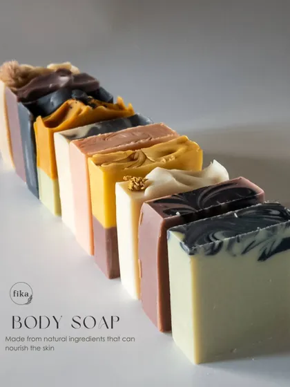 Behold the beautiful diversity of my body soap collection. Each bar is a unique piece of art, formulated with natural, plant-based ingredients to nourish the skin. This lineup shows the variety of colors and textures I can create, all derived from natural sources like mineral clays and botanicals.