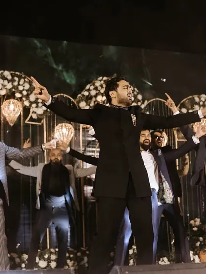 A powerful 'boy band' pose from a groomsmen performance. This kind of synchronized, high-energy act is always a crowd favourite.