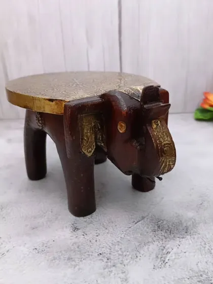 A side view of the wooden elephant bajoth, showing its sturdy construction and artistic form.