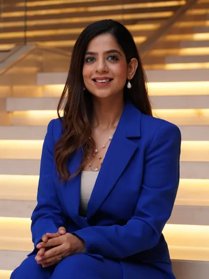 A close-up in the blue suit, showcasing the clean lines and confident aesthetic I bring to my corporate hosting assignments.