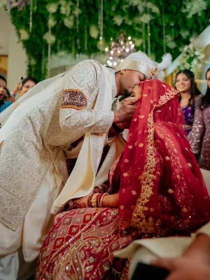 A tender kiss seals the vows. This intimate moment during the ceremony is a beautiful expression of the couple's new union, captured candidly.
