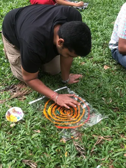 Another participant creating a colorful spiral artwork during our wellbeing circle in the park.