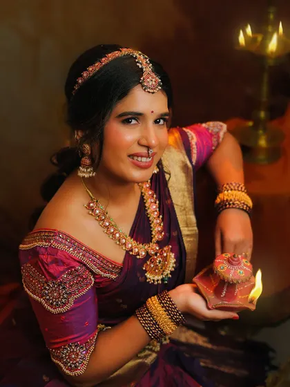 Holding a lit deepa during Diwali. The lamp symbolizes the victory of light over darkness, a core message that I love to share through my work.