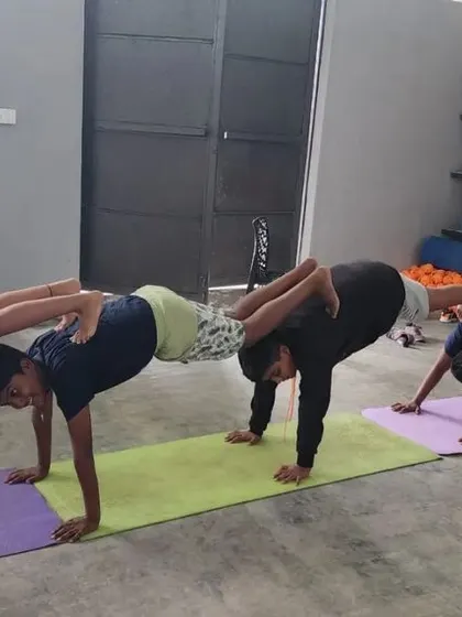 A four-person plank train, showing how we build on foundational poses to create more complex group challenges.
