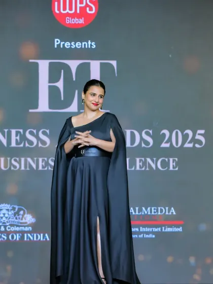 A wider shot of Vidya Balan on the ET Business Awards stage, showing the event branding in the background. This image connects the high-profile guest with the event itself, adding credibility and prestige.