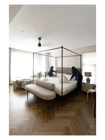 A behind-the-scenes shot of our team adding the final touches to the master bed, ensuring every detail is perfect.