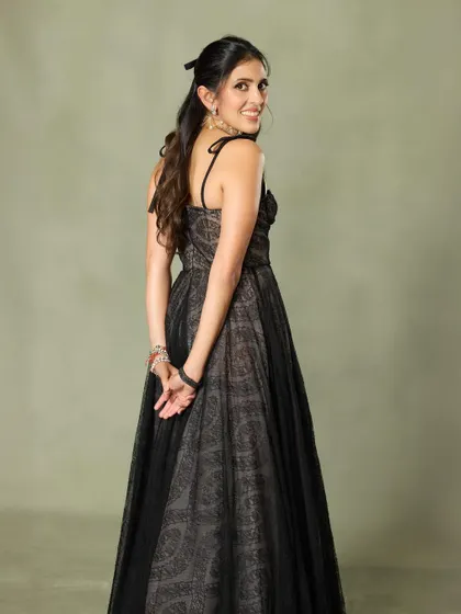 Effortless grace in this black Giambattista Valli gown. The sheer overlay and delicate print create a look that is both romantic and mysterious.