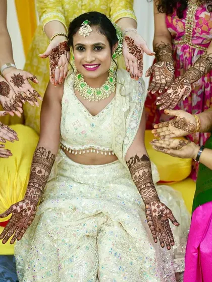 A lovely group photo of the bride with her bridesmaids, all showing off their henna. It's always a pleasure to be part of these fun-filled celebrations.