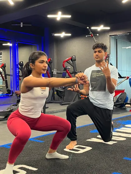 Sweat, determination, and a whole lot of heart. A coach guides a client through a perfect squat, demonstrating our hands-on approach to form and technique.