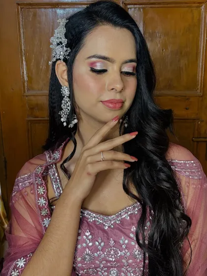 A close-up pose that highlights the nails and the delicate hand position.