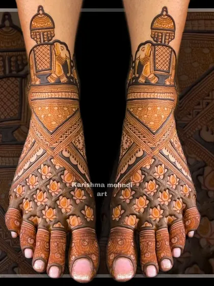 An example of my detailed bridal feet mehendi, ensuring beauty from head to toe. This design features a dense pattern of lotus flowers across the top of the feet, complemented by elephant motifs and geometric patterns for a balanced and elegant finish.