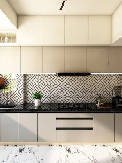 The other side of the kitchen, showing handleless cabinets for a clean look and a patterned backsplash that adds visual interest.