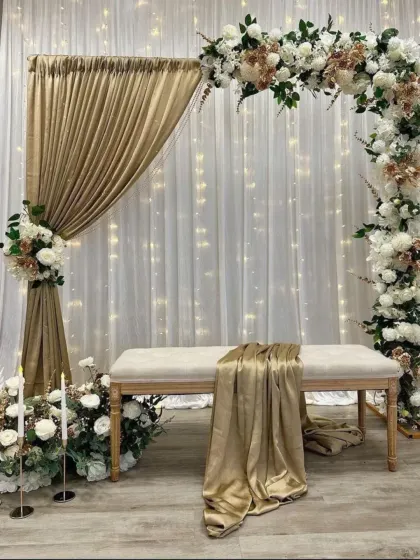 For a more elegant and sophisticated look, I created this stage with a white and gold theme. The setup includes a floral arch, soft drapery with fairy lights, and candle accents for a truly romantic feel.