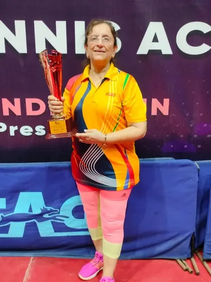 Age is no barrier to success. One of our veteran players proudly displays her championship trophy, proving that passion and hard work are timeless.