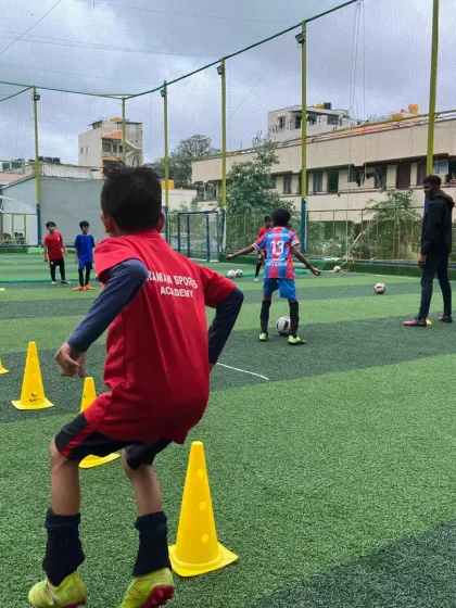 A view from behind a player during a cone drill, showing the setup of our U9 and U11 preseason training.